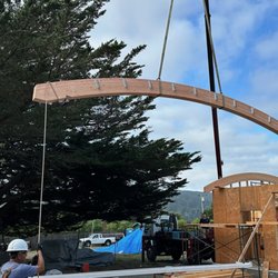 Ad-Lite Crane Service - Lifting one of the 24' long curved beams .