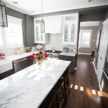 Wood Wise - a kitchen with a marble island - Flooring Near Me Wood Wise - a kitchen with a marble island - Flooring Near Me