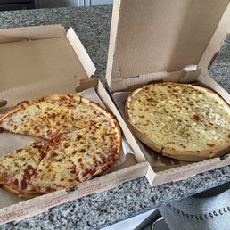 two pizzas in open boxes two pizzas in open boxes