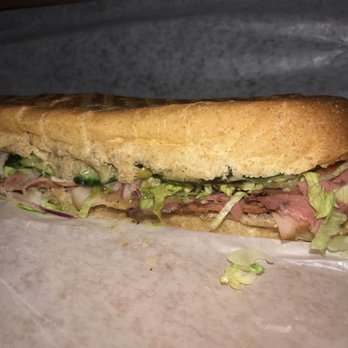 Sicily's Pizza - a sub sandwich with meat and lettuce - Pizza Near Me - London, Ontario Sicily's Pizza - a sub sandwich with meat and lettuce - Pizza Near Me - London, Ontario