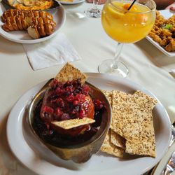 Sycamore Grille - Sausage and cheese dip with soft pretzels in back, white sangria, baked brie and fig
