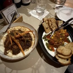 oxtail with grits on the left, roasted squash dip on the right oxtail with grits on the left, roasted squash dip on the right