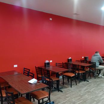 The Slice Shop - a man sitting at a table - Pizza Near Me - Chicago, Illinois