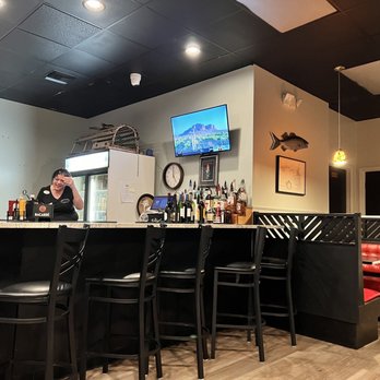 Red Grouper Tavern - a woman sitting at the bar - Seafood Near Me - Venice, Florida Red Grouper Tavern - a woman sitting at the bar - Seafood Near Me - Venice, Florida