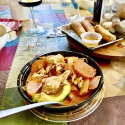 Chicken Massaman Curry with Avocado; Vegetable Spring Rolls (in the background).