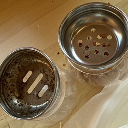 Pizzeria Violetta - Underside of cheese and pepper shakers.