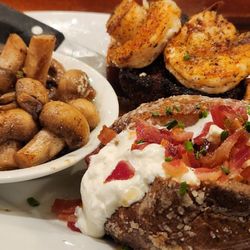 Stonewood Grill & Tavern - Steak covered with shrimp, sautéed mushrooms and loaded baked potato.