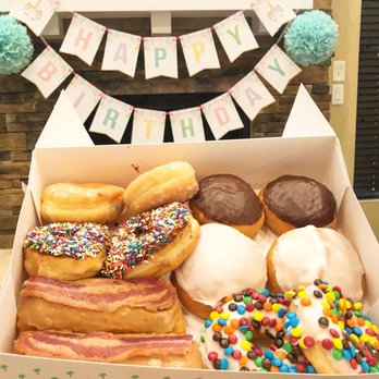 Paradise Donuts - A box of absolute wonderfulness! The white covered donut was loaded with blueberry filling and it was amazing! - Donuts Near Me - Hebron, Kentucky