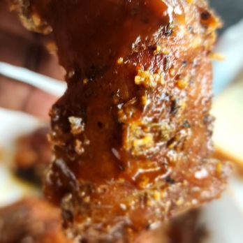 Smokin' Jonny's BBQ - hand holding a piece of meat - Barbeque Near Me - Gardena, California Smokin' Jonny's BBQ - hand holding a piece of meat - Barbeque Near Me - Gardena, California