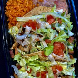 Taquitos Chicago - Chicken tacos with lettuce, tomato, onions, cilantro, and cheese with rice and beans.