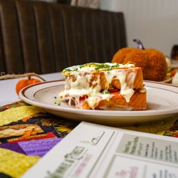 Winnie & Ethel's Downtown Diner - Ham, provolone, and creamy Mornay sauce on Texas toast, topped with an egg cooked to your choice and finished with fresh chives.
