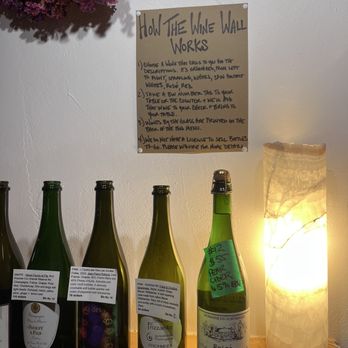 Corner Office - You can choose a bottle from the wall and drink that at your table but you can't buy it to take home - Wine Bars Near Me - Taos, New Mexico