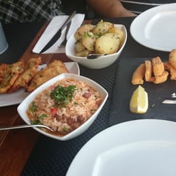 Fish cakes, rice with beans, boiled potatoes,  fried cuttlefish