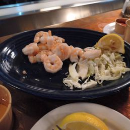Half eaten plate of steamed prawns Half eaten plate of steamed prawns