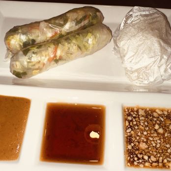 Thai Drift - Would not recommend this - Two Vietnamese spring rolls wrapped in rice paper are placed on a white rectangular plate with three different dipping sauces. - Thai Near Me - Orem, Utah