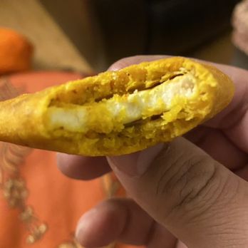 Bombay Chaat House - a hand holding a piece of food - Indian Near Me - Milpitas, California