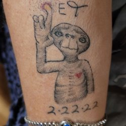 New Inkland Tattoo - Angel   added a heart and glowing finger for my late husband's 70th birthday to my ET tattoo in honor of my husband
