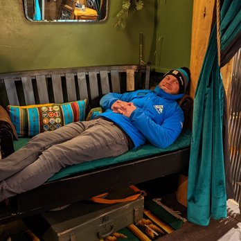 Canteen at Campfire Hotel - a man laying on a bed - Lounges Near Me - Bend, Oregon Canteen at Campfire Hotel - a man laying on a bed - Lounges Near Me - Bend, Oregon