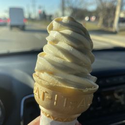 ows a hand holding a cone of ice cream ows a hand holding a cone of ice cream