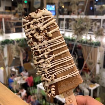 Popbar - Coffee gelato with almond/dark chocolate half dip and white chocolate drizzle - Desserts Near Me - Anaheim, California Popbar - Coffee gelato with almond/dark chocolate half dip and white chocolate drizzle - Desserts Near Me - Anaheim, California