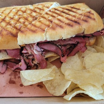 The Deli on Crown - Pastrami sandwich on french bread with chips - Delis Near Me - Mequon, Wisconsin