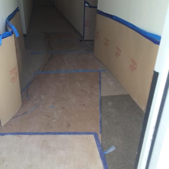Masonite On The Floor And Wall Protection Keeps The Carpet From