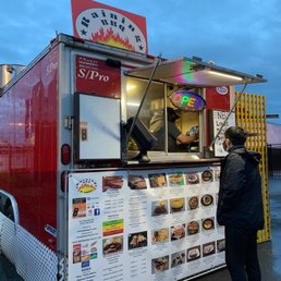 a man standing in front of a food truck