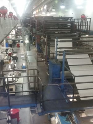 Photo of Tampa Bay Times - Saint Petersburg, FL, US. The plates are locked into position on the printing press, and the paper has been fed up from the lower floor.