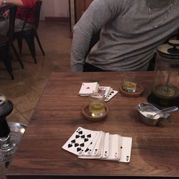 a man sitting at a table with playing cards
