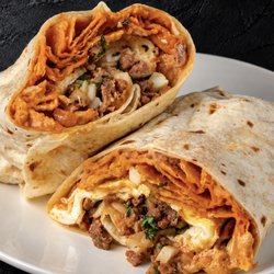 Fuego Cravings - A 13" flour tortilla loaded with hearty beans, saucy red chilaquiles, eggs, savory angus asada, sour cream, cotija cheese, onion/cilantro