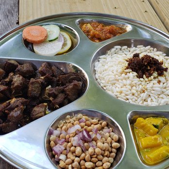 While In Kathmandu - Goat meat, puffed rice, tomato and radish salsa, crunchy soybean seeds, and pieces of cucumbers/radish. - Cafes Near Me - Ridgewood, New York While In Kathmandu - Goat meat, puffed rice, tomato and radish salsa, crunchy soybean seeds, and pieces of cucumbers/radish. - Cafes Near Me - Ridgewood, New York