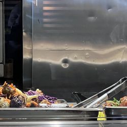 Here is the food that supposed to be hot out on top of a table. The food is always cold.
