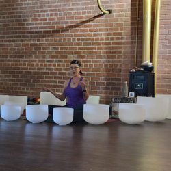 Barefoot Studio - Yvonne discussing the class, surrounded by meditation bowls