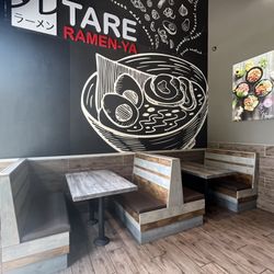 Booths with previous restaurant's art