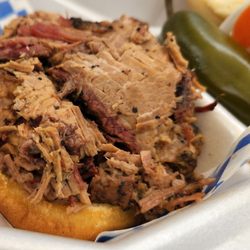 Albuquerque Slow Smoked BBQ - Smoked BBQ beef brisket sandwich close up.