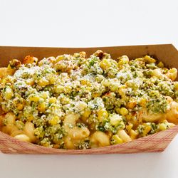 Mac Dynamite - Chicago - Elote Mac! OG Mac topped with roasted corn, jalapeño, cilantro, vegan mayo, cotija, & chili pepper-paprika sprinkle.