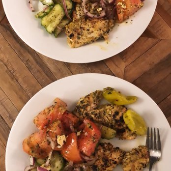 Sparta - two plates of food on a wooden table - Greek Near Me - Montreal, Quebec Sparta - two plates of food on a wooden table - Greek Near Me - Montreal, Quebec