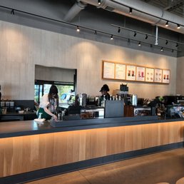 a woman standing at a counter in a coffee shop a woman standing at a counter in a coffee shop