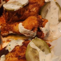 Nashville hot wings with house ranch and pickles.