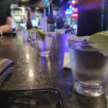 McCarthys - a shot of a drink on a bar counter - Irish Pub Near Me - Brownsville, Texas McCarthys - a shot of a drink on a bar counter - Irish Pub Near Me - Brownsville, Texas