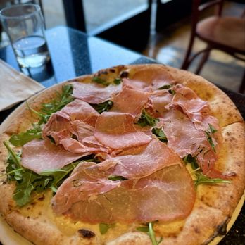 Napoletana Pizzeria - BIANCA AL PROSCIUTTO Fresh mozzarella and garlic topped with Parma prosciutto and arugula (no tomato sauce). - Italian Near Me - Mountain View, California Napoletana Pizzeria - BIANCA AL PROSCIUTTO Fresh mozzarella and garlic topped with Parma prosciutto and arugula (no tomato sauce). - Italian Near Me - Mountain View, California