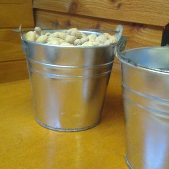Texas Roadhouse - A bucket of roasted peanuts, and one for the discarded shells. - Barbeque Near Me - Riverview, Florida