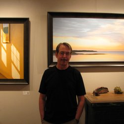 North Water Gallery - Artist Jim Holland in front of his paintings