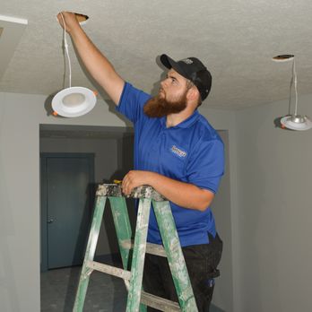 Bassett Services - Technician installing light fixture - Heating & Air Conditioning/HVAC Near Me - Plainfield, Indiana Bassett Services - Technician installing light fixture - Heating & Air Conditioning/HVAC Near Me - Plainfield, Indiana