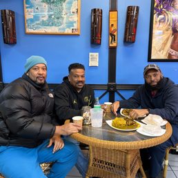 3 old friends enjoying a tasty goat Roti