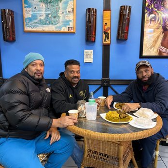 Limin's Cafe Caribe - 3 old friends enjoying a tasty goat Roti - Caribbean Near Me - East Orange, New Jersey