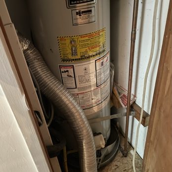 Thumbs Up Rooter And Plumbing - Before - the back of the "room" with the standard water heater - Plumbing Near Me - Oakland, California