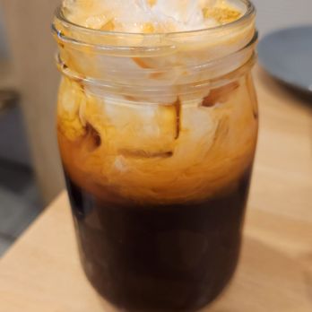 Nom Nam - a glass of iced coffee on a table - Vietnamese Near Me - New York, New York Nom Nam - a glass of iced coffee on a table - Vietnamese Near Me - New York, New York