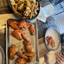 Birdhouse Wingerie & Bar - Classic poutine and sweet and sour wings with ketchup wings. Really good.