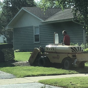 AAA Arborist Tree Experts - Michael grinding the stump - Tree Services Near Me